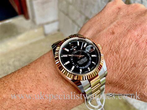 rolex sky dweller black dial gold and steel